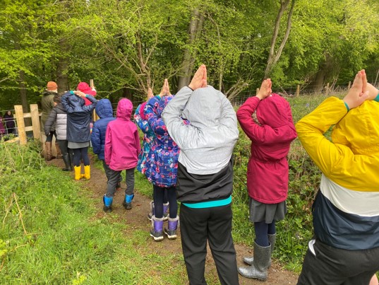 school children praying on walk 